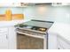 Close up of stainless steel cooktop in renovated kitchen with white cabinets and subway tile at 1550 W Saint Kateri Dr, Phoenix, AZ 85041