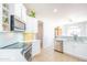 Kitchen with stainless steel appliances, white cabinets, light backsplash, and view to the dining area at 1550 W Saint Kateri Dr, Phoenix, AZ 85041