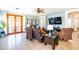 Comfortable living room boasts tile floors, a ceiling fan, and double doors leading to the backyard at 1550 W Saint Kateri Dr, Phoenix, AZ 85041