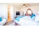 Main bedroom featuring a ceiling fan, large windows, and a view of the en suite bathroom at 1550 W Saint Kateri Dr, Phoenix, AZ 85041