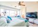 Bright main bedroom with large windows, ceiling fan, and views to en suite bathroom and walk-in closet at 1550 W Saint Kateri Dr, Phoenix, AZ 85041