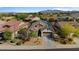 Aerial view of a house in a beautiful neighborhood with mountain views in the background at 15665 W Coronado Rd, Goodyear, AZ 85395