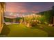 Entertainer's backyard features a putting green, outdoor kitchen, and pool, perfect for outdoor living at 15665 W Coronado Rd, Goodyear, AZ 85395