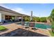 Backyard showcases a pool, patio seating, and lush landscaping for outdoor relaxation at 15665 W Coronado Rd, Goodyear, AZ 85395