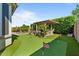 Spacious backyard featuring a pool, putting green, and outdoor kitchen, perfect for entertaining at 15665 W Coronado Rd, Goodyear, AZ 85395