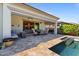 Backyard featuring a refreshing pool with a tanning ledge, a patio, and a covered barbecue area at 15665 W Coronado Rd, Goodyear, AZ 85395