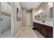 This bathroom features a double vanity and tile flooring at 15665 W Coronado Rd, Goodyear, AZ 85395