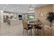 Bright open-concept dining area with modern lighting, flows into the kitchen and living spaces at 15665 W Coronado Rd, Goodyear, AZ 85395