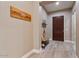Inviting entryway with decorative sign, bench seating and wood-look tile floors at 15665 W Coronado Rd, Goodyear, AZ 85395