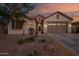 Charming single-story home boasts a stone accent entry and a meticulously xeriscaped front yard at 15665 W Coronado Rd, Goodyear, AZ 85395
