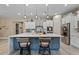 Open kitchen featuring an island with bar seating, stainless steel appliances, and tiled backsplash at 15665 W Coronado Rd, Goodyear, AZ 85395