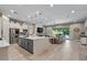 Open-concept kitchen with stainless appliances, granite island, and views of the living area and pool at 15665 W Coronado Rd, Goodyear, AZ 85395