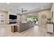 Spacious living room features a cozy fireplace, a modern ceiling fan, and bright sliding doors at 15665 W Coronado Rd, Goodyear, AZ 85395