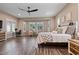 Bright main bedroom with a fan, wood floors, ample windows, and a built-in desk at 15665 W Coronado Rd, Goodyear, AZ 85395