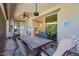 Covered outdoor patio with seating, a fan, and sliding glass doors leading inside at 15665 W Coronado Rd, Goodyear, AZ 85395