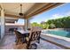 Inviting outdoor patio with comfortable seating and views of the pool and lush backyard at 15665 W Coronado Rd, Goodyear, AZ 85395