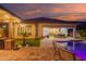 The covered patio seamlessly connects indoor and outdoor living spaces, overlooking the pool at 15665 W Coronado Rd, Goodyear, AZ 85395