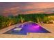 Inviting backyard pool with travertine surround, a swim-up table, and lush green landscaping at 15665 W Coronado Rd, Goodyear, AZ 85395