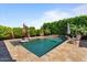 A serene pool with waterfall feature is surrounded by lush landscaping and offers a relaxing backyard retreat at 15665 W Coronado Rd, Goodyear, AZ 85395