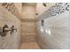Shower with neutral colored tile and decorative tile accents at 15665 W Coronado Rd, Goodyear, AZ 85395