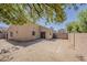 This desert backyard features a rock feature, patio and a brick fence surrounding the perimeter at 15962 W Gibson Ln, Goodyear, AZ 85338