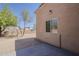 A desert landscaped backyard with desert trees and a concrete patio at 15962 W Gibson Ln, Goodyear, AZ 85338