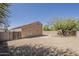 Spacious backyard featuring desert landscaping, block wall and patio access at 15962 W Gibson Ln, Goodyear, AZ 85338