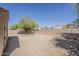 Wide angle view of the backyard featuring desert landscaping, block wall and patio access at 15962 W Gibson Ln, Goodyear, AZ 85338
