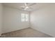 Neutral bedroom with a ceiling fan and a window with blinds for natural light at 15962 W Gibson Ln, Goodyear, AZ 85338