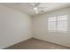 Clean bedroom with a ceiling fan and a bright window at 15962 W Gibson Ln, Goodyear, AZ 85338