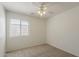 Neutral bedroom with a ceiling fan and a window with blinds for natural light at 15962 W Gibson Ln, Goodyear, AZ 85338