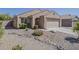 Charming single-story home featuring desert landscaping and a tile roof at 15962 W Gibson Ln, Goodyear, AZ 85338
