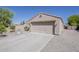 Attached two car garage with adjacent driveway and minimal desert landscaping at 15962 W Gibson Ln, Goodyear, AZ 85338