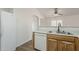 Well-lit kitchen features white appliances, wood cabinets and an open layout to other living spaces at 15962 W Gibson Ln, Goodyear, AZ 85338