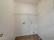 A laundry room with a vinyl floor, shelving, and utility hookups ready for appliances at 15962 W Gibson Ln, Goodyear, AZ 85338