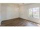 Bright living room featuring wood-look floors and natural lighting at 15962 W Gibson Ln, Goodyear, AZ 85338