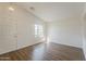 Bright living room featuring wood-look floors and natural lighting at 15962 W Gibson Ln, Goodyear, AZ 85338