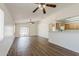 Bright living room featuring wood-look flooring and open access to kitchen at 15962 W Gibson Ln, Goodyear, AZ 85338