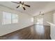 Open living room featuring modern ceiling fans and wood-look floors at 15962 W Gibson Ln, Goodyear, AZ 85338