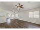 Bright living room featuring archways, ceiling fans, and wood-look flooring at 15962 W Gibson Ln, Goodyear, AZ 85338