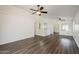 Open living room featuring ceiling fans, wood-look floors, and bright lighting at 15962 W Gibson Ln, Goodyear, AZ 85338