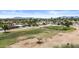 Aerial view showcases the property's proximity to the golf course and surrounding neighborhood with mountain views at 1641 S Sossaman Rd, Mesa, AZ 85209