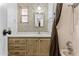 Bathroom features a sink, vanity, mirror, and shower with brown curtain at 1641 S Sossaman Rd, Mesa, AZ 85209