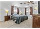 Cozy bedroom with neutral carpet, ceiling fan, and ample natural light from the two windows at 1641 S Sossaman Rd, Mesa, AZ 85209