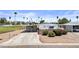 Charming home with a long driveway, small garden area, and well-maintained lawn at 1641 S Sossaman Rd, Mesa, AZ 85209