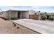 Wide driveway with carport and small shrubs in gravel yard at 1641 S Sossaman Rd, Mesa, AZ 85209