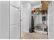 Hallway with carpeted floors and a built-in storage closet with shelves and hanging space at 1641 S Sossaman Rd, Mesa, AZ 85209