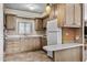 Bright kitchen with light-toned wood cabinetry, white appliances, and a convenient breakfast bar area at 1641 S Sossaman Rd, Mesa, AZ 85209