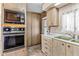 Kitchen features a built-in oven, cabinets, a sink and sliding door pantry at 1641 S Sossaman Rd, Mesa, AZ 85209