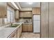 Cozy kitchen with wood cabinets, and white appliances in a well-lit room at 1641 S Sossaman Rd, Mesa, AZ 85209